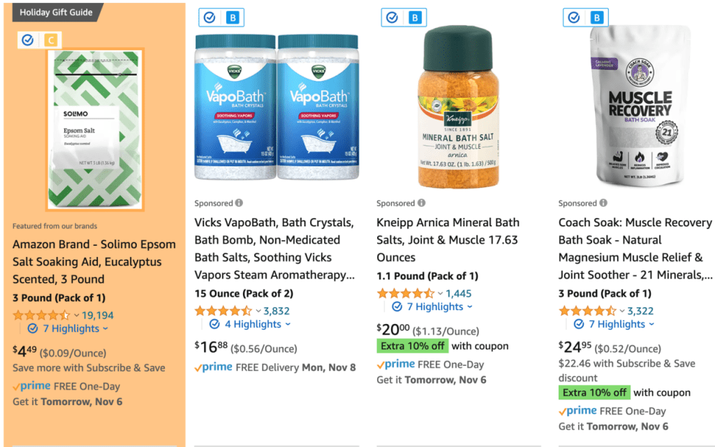 Screenshot einer Amazon-Suchseite für Badesalz, bei der das erste Ergebnis (Solimo Epson Salt) von der orangen Markierung der Brand Detector App umgeben ist. Über dem Bild im Ergebnis befindet sich ein kleines "c" in einem gelben Quadrat, das die Fakespot-Bewertung anzeigt.